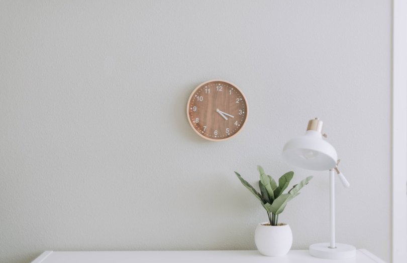white desk and wooden clock